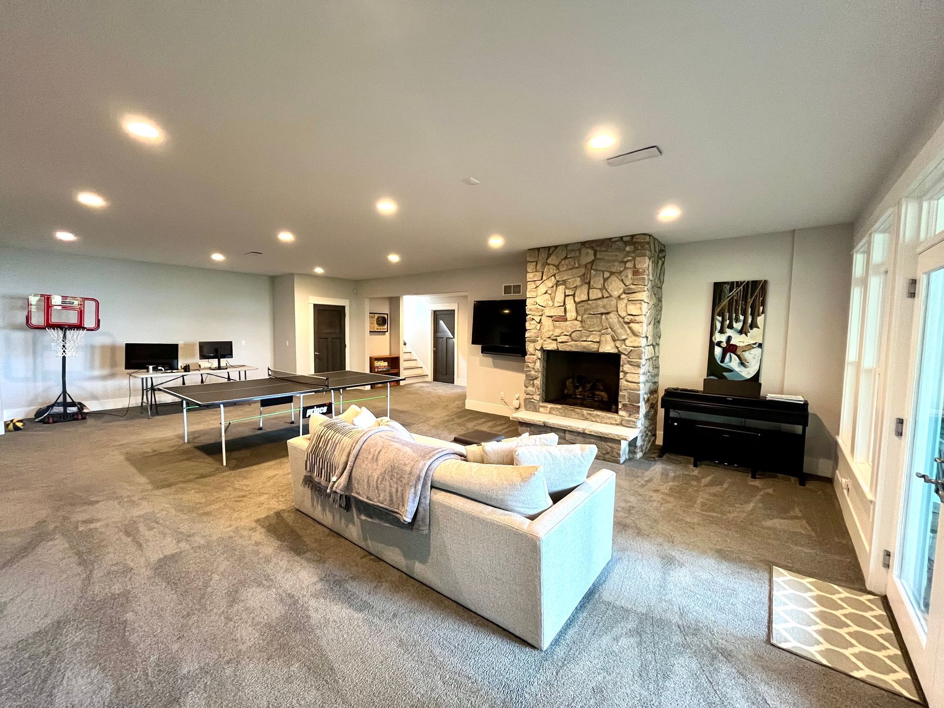 A living room with a couch , fireplace , table and television.