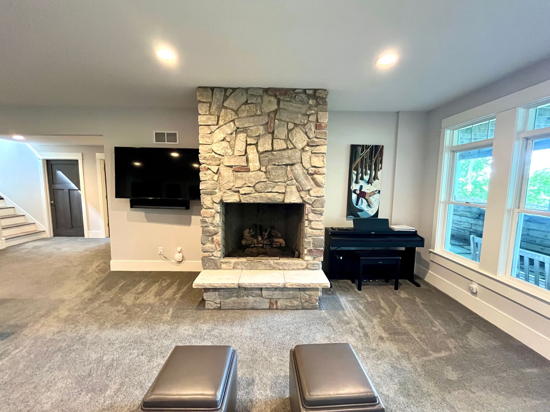A living room with a fireplace and a flat screen tv.