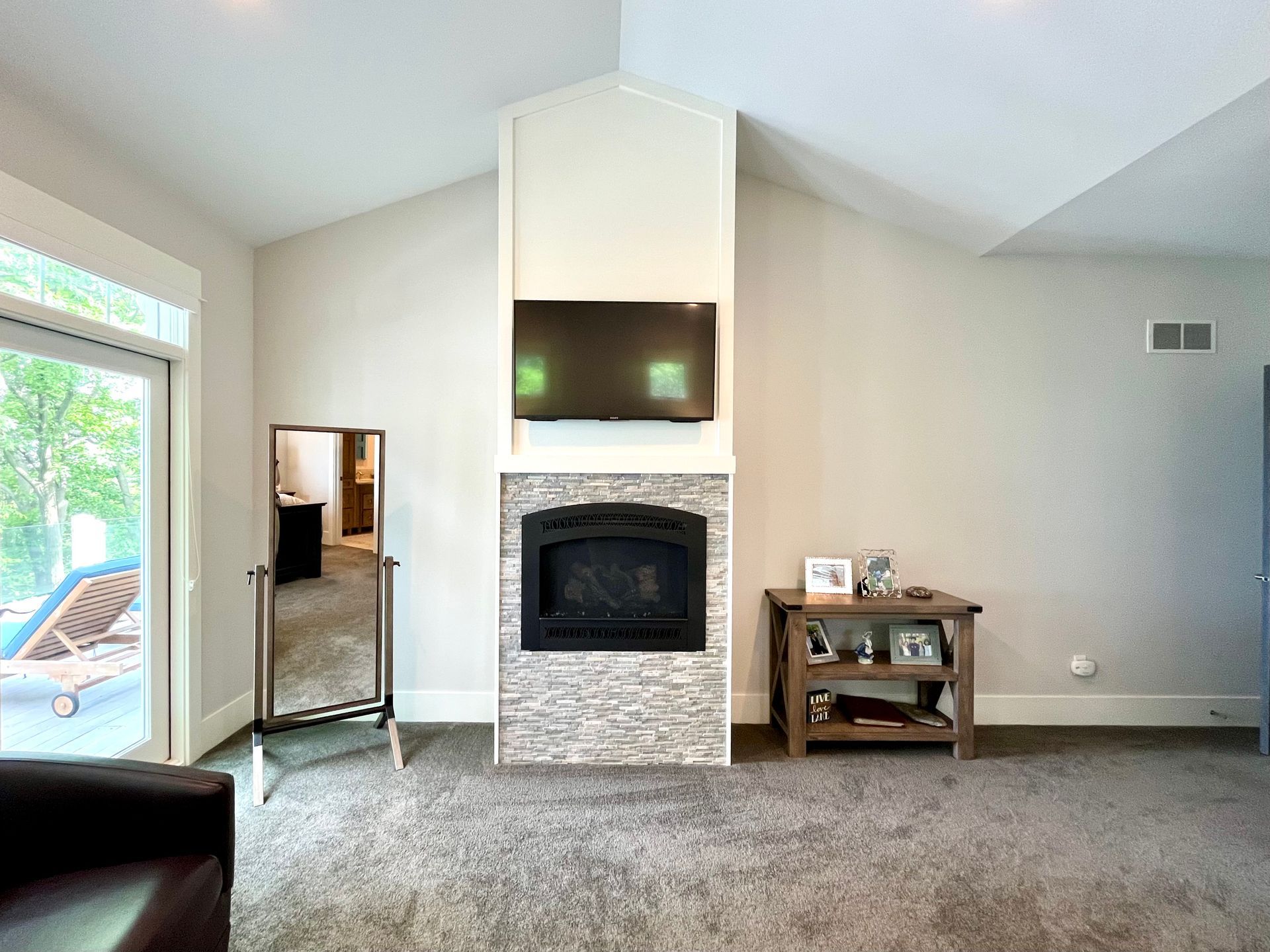 A living room with a fireplace and a flat screen tv.