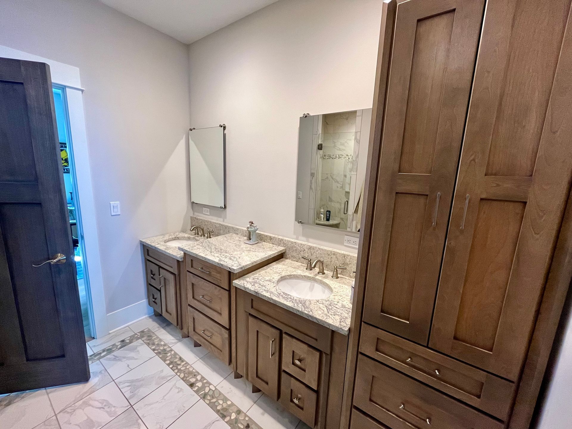 A bathroom with two sinks and a mirror.
