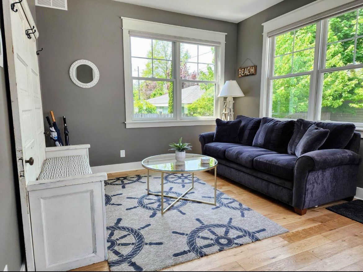 A living room with a couch , coffee table , and rug.