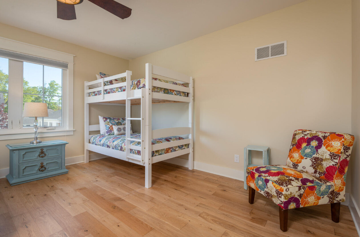 There is a bunk bed and a chair in the room.