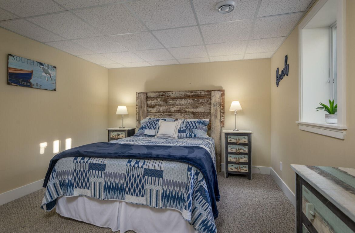 A bedroom with a large bed and two nightstands