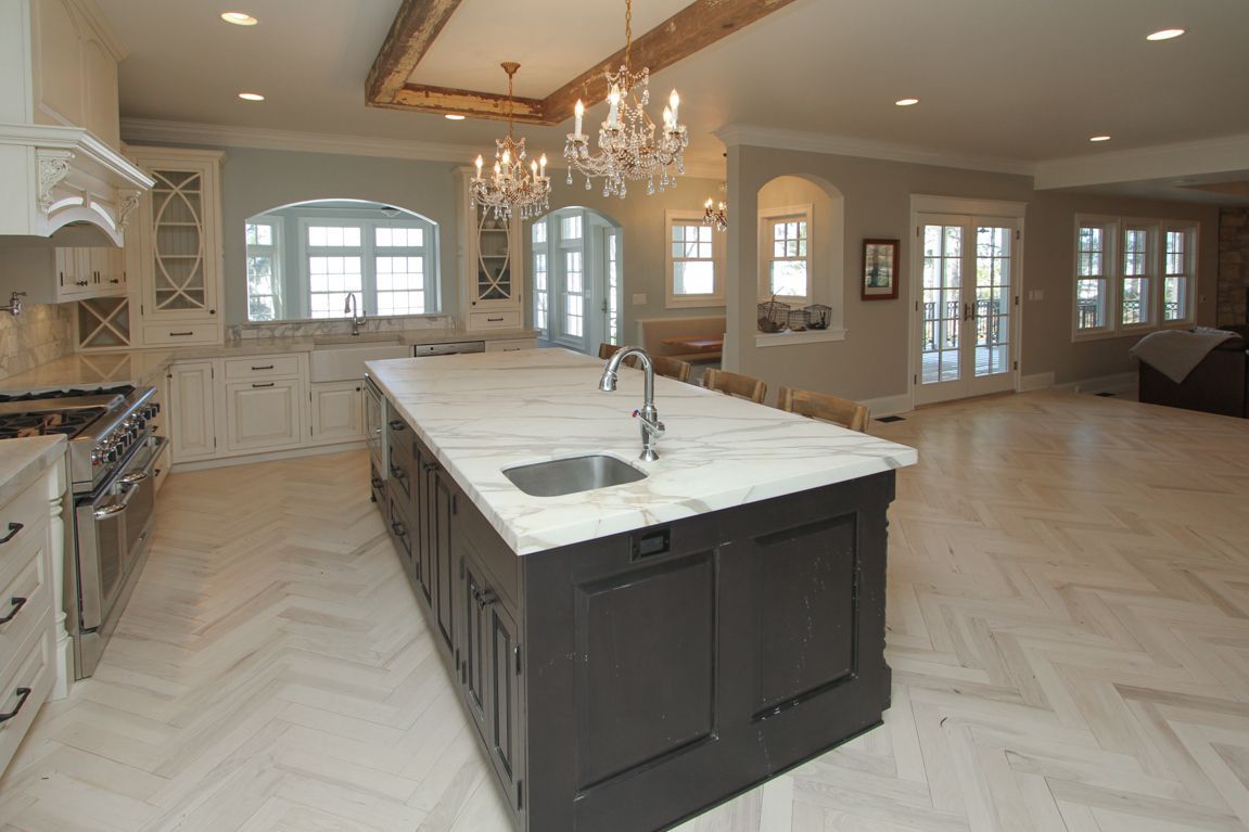 A kitchen with a large island and a sink