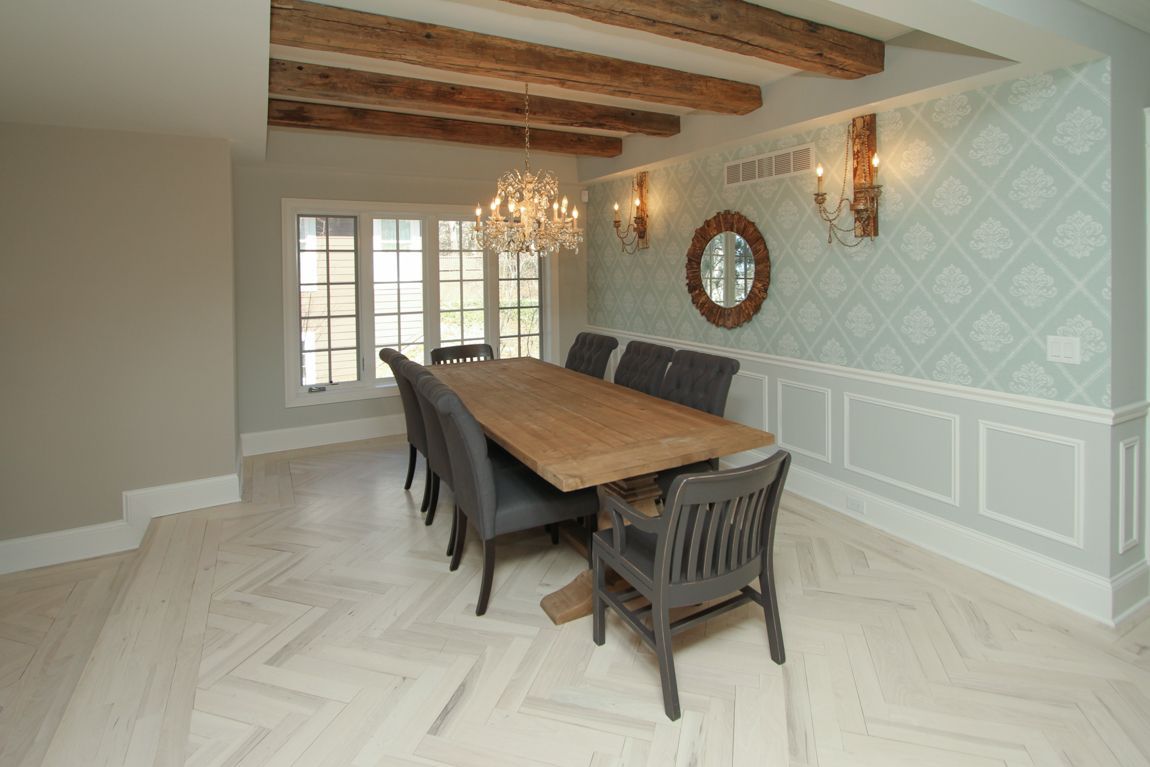 A dining room with a long wooden table and chairs