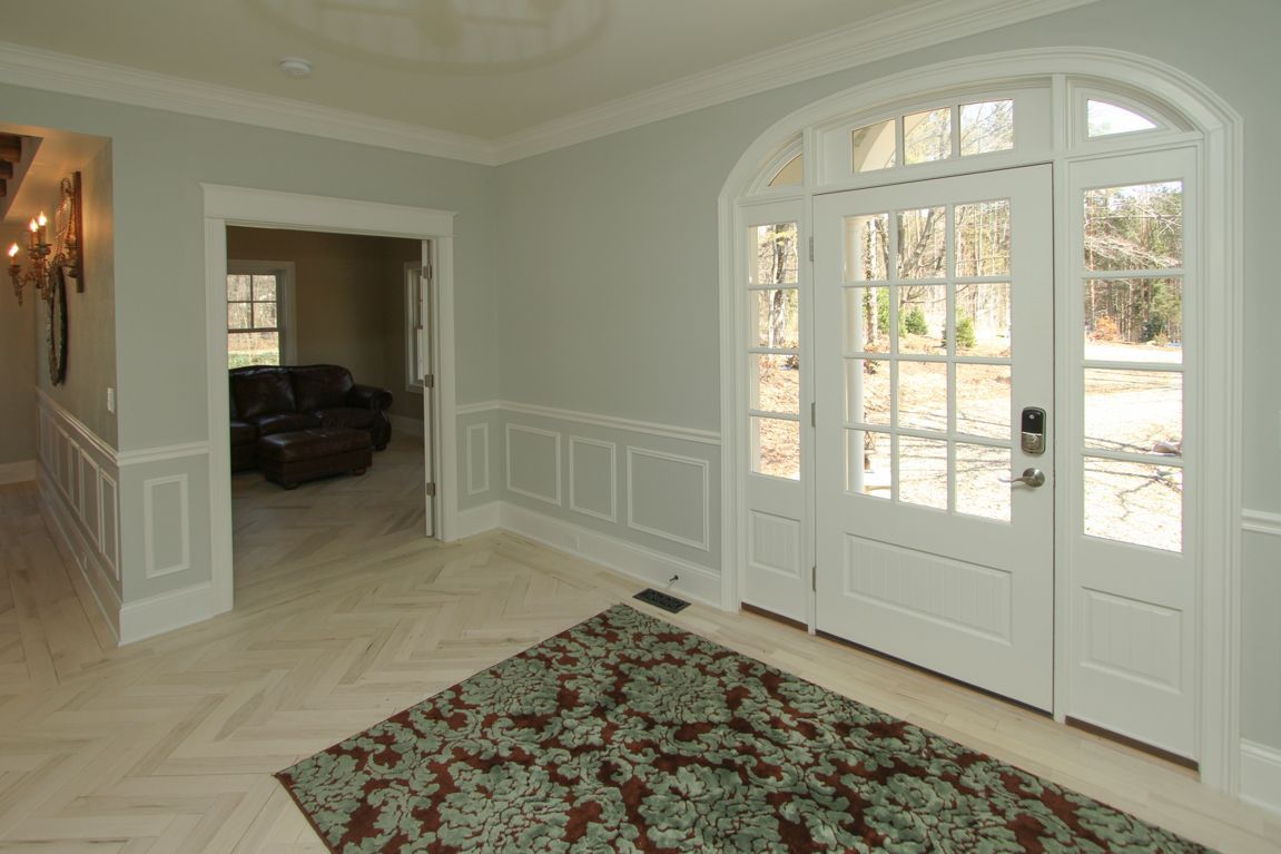 A living room with a rug and a couch in it