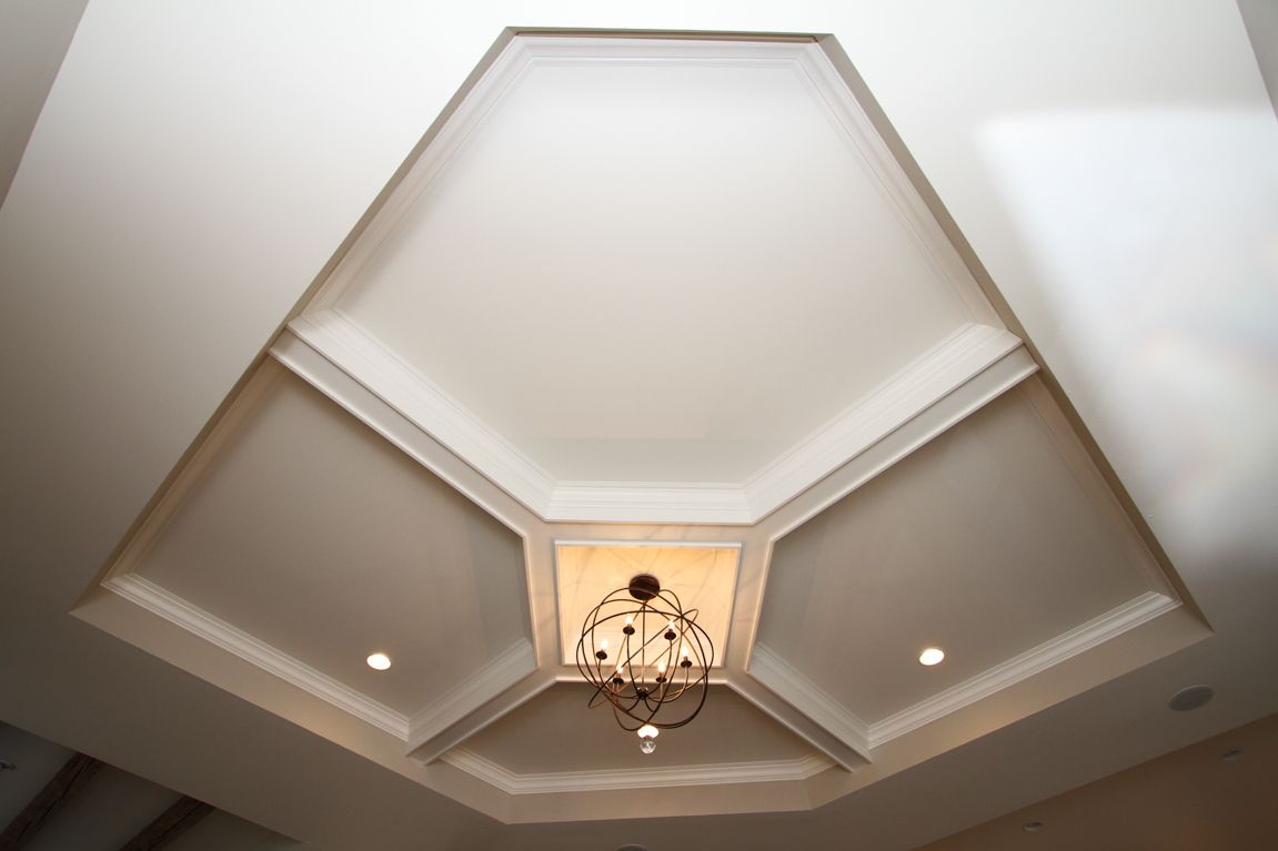 A white ceiling with a chandelier hanging from it