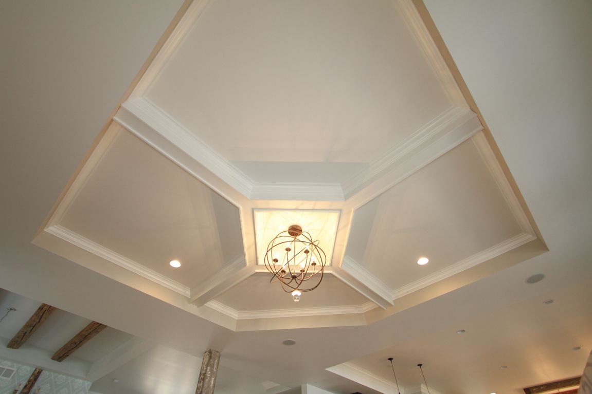 A white ceiling with a chandelier hanging from it