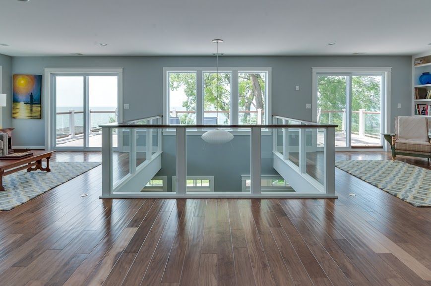 A living room with hardwood floors and lots of windows
