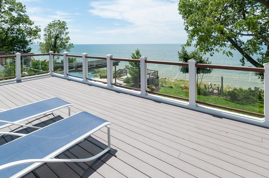 A deck with chairs and a view of the ocean