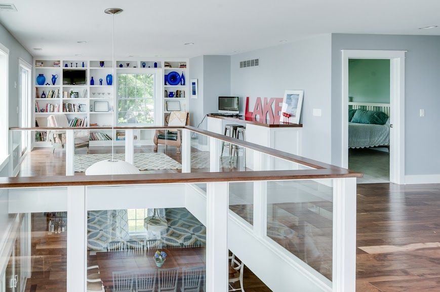 A view of a living room from the second floor of a house.