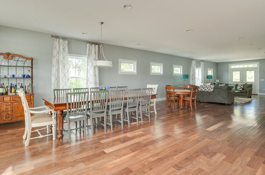 There is a dining table and chairs in the middle of the room.