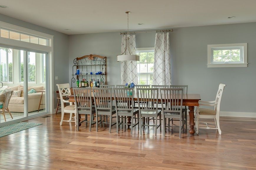 A large dining room with a long table and chairs.