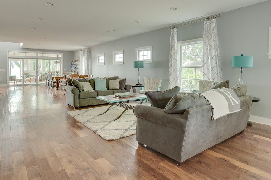 A living room with two couches , a coffee table , and a rug.