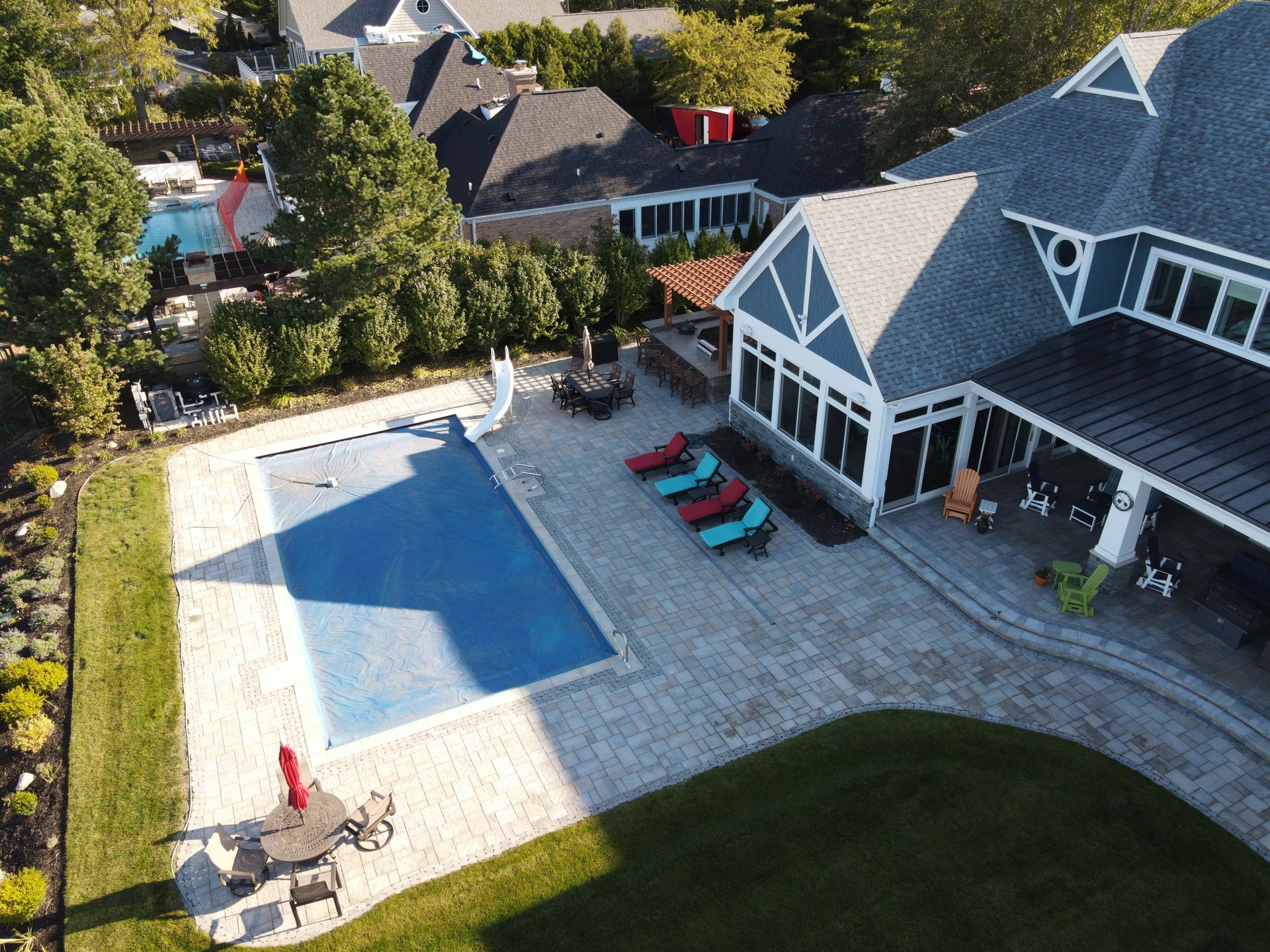 An aerial view of a large house with a large swimming pool