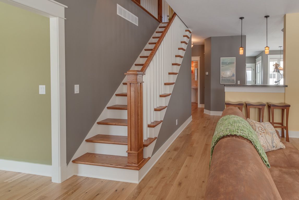 A living room with a staircase leading up to the second floor