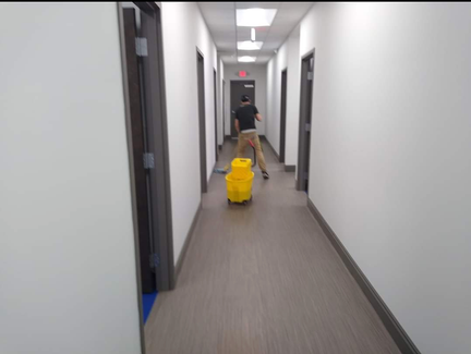 Worker Cleaning the Corridor