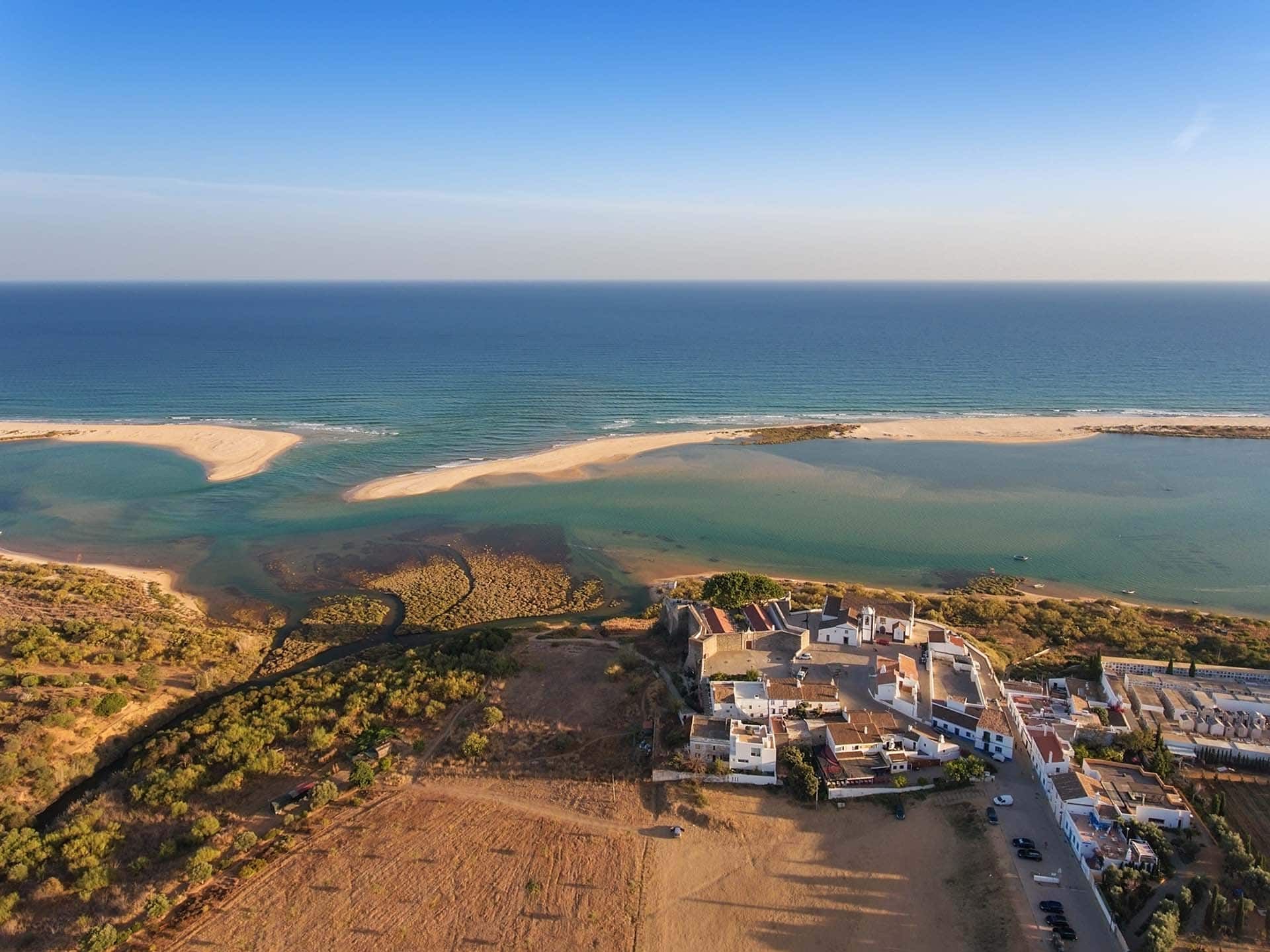 An aerial view of a small town next to the ocean.