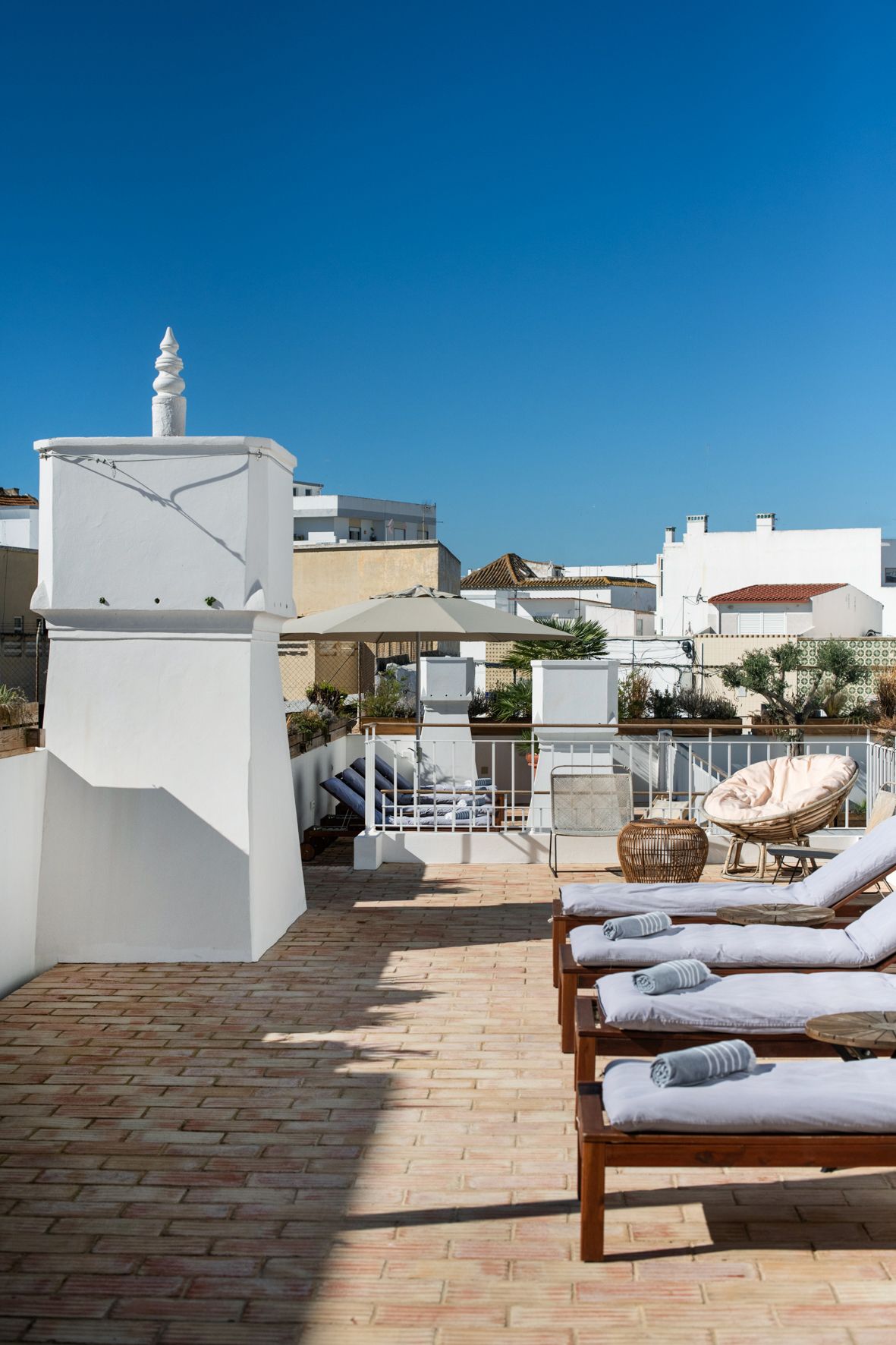 there are a lot of chairs and umbrellas on the patio .