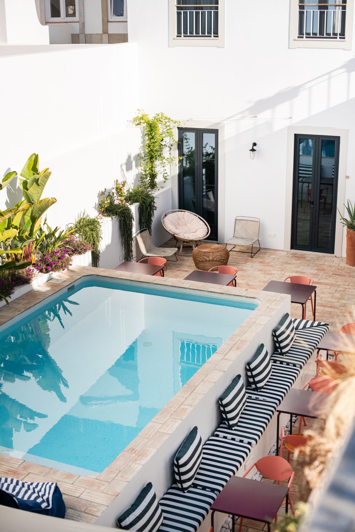 an aerial view of a large swimming pool surrounded by chairs and tables .