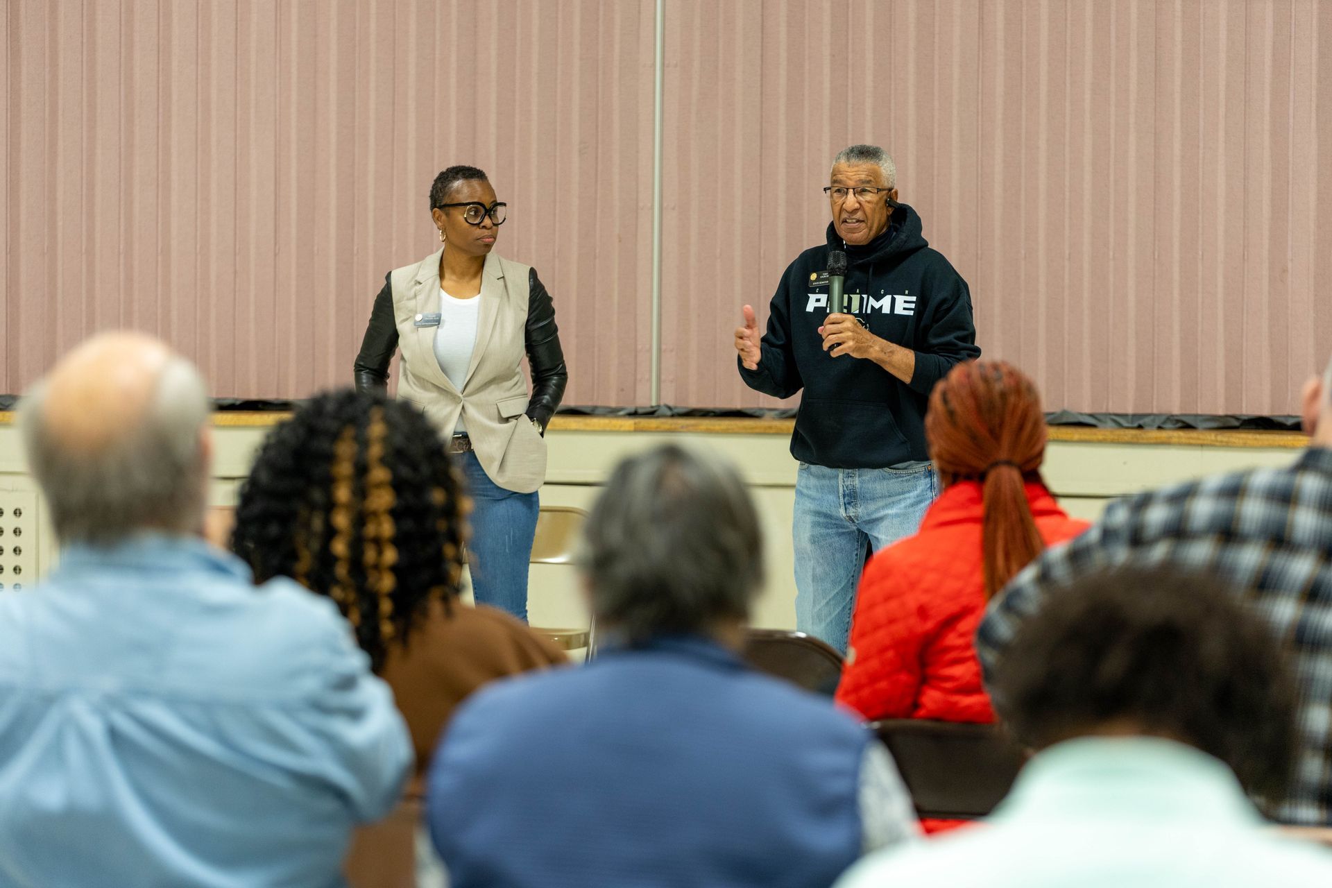 Two officials speak at a town hall