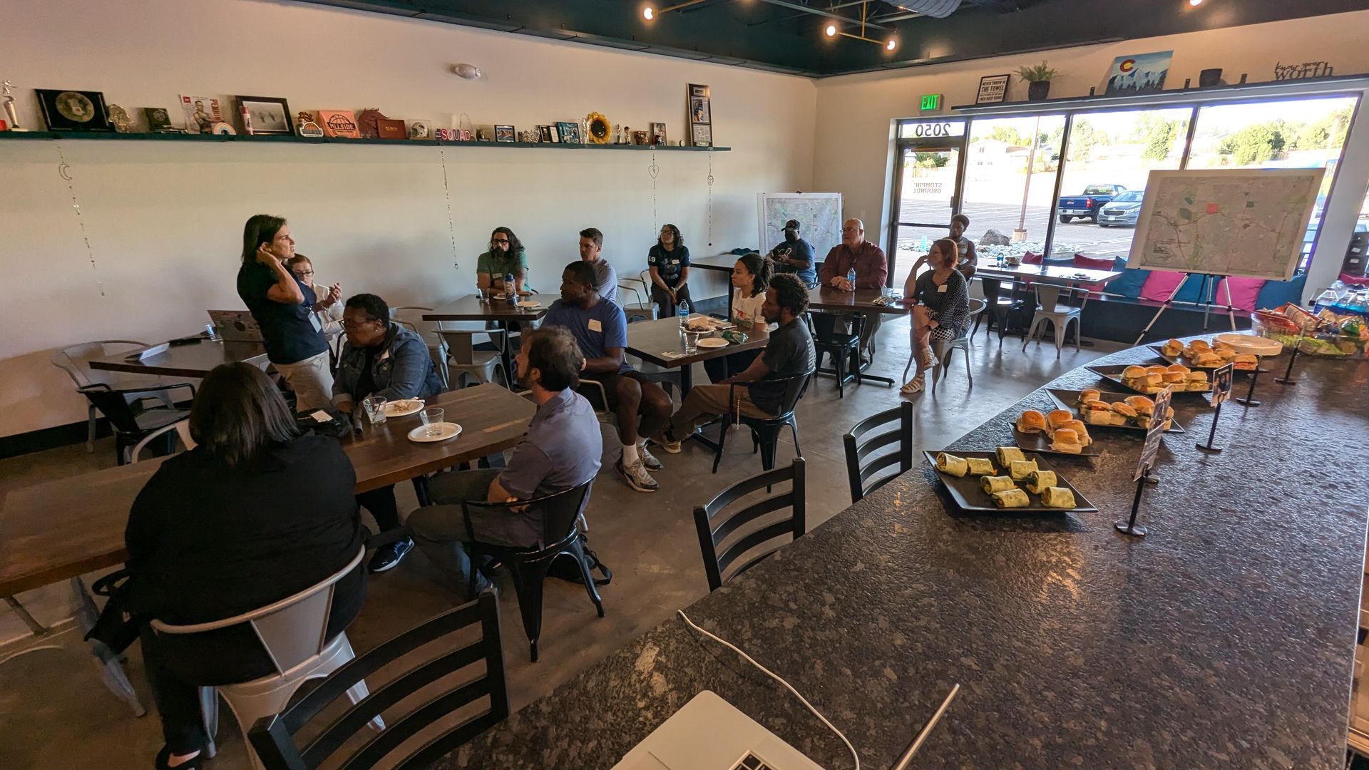 A group of people are sitting at tables in a restaurant.