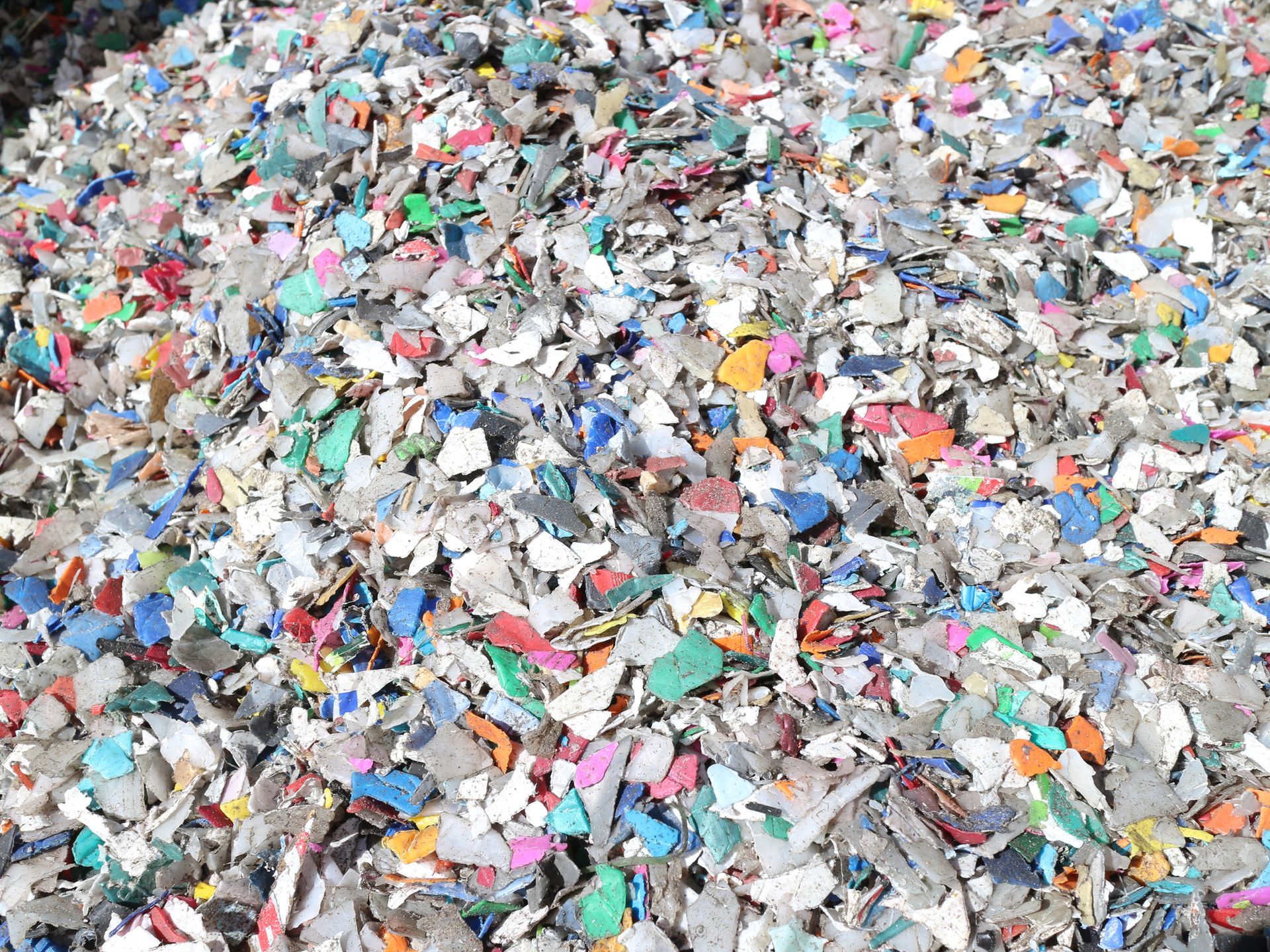 Stack of papers next to a pile of shredded paper, demonstrating destruction of documents.