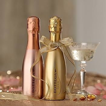 A bottle of angels envy triple barrel bourbon next to a glass of bourbon on a tray.