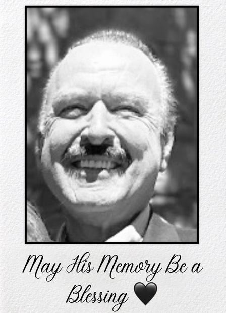 Black and white portrait of a smiling man with a mustache. Text below reads 