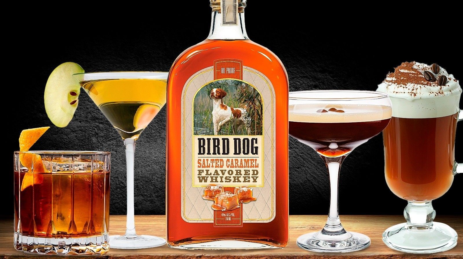 Bottle of Grande Absente absinthe liqueur, green and white label, set on dried herbs.