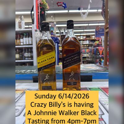 Two Johnnie Walker Black bottles on a counter with a yellow sale sign in a store.