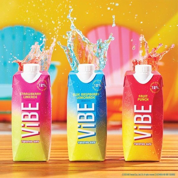 Three Vibe juice boxes, Strawberry, Blue Raspberry, and Fruit Punch, with splashing juice against a colorful background.