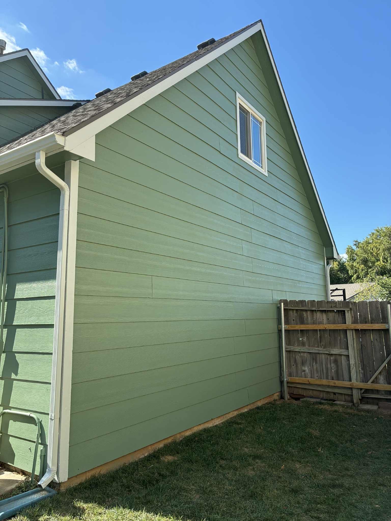 The back of a house with a large deck and stairs