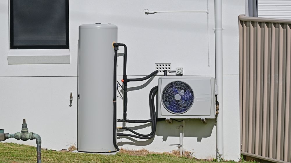 Water Heater and Air Conditioning Unit Mounted on Exterior Wall — Oxplumb in Coolum Beach, QLD