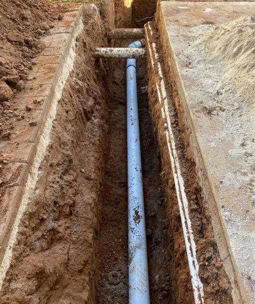 A Trench With a Gray Pipe Running Down the Center — Oxplumb in Gympie, QLD
