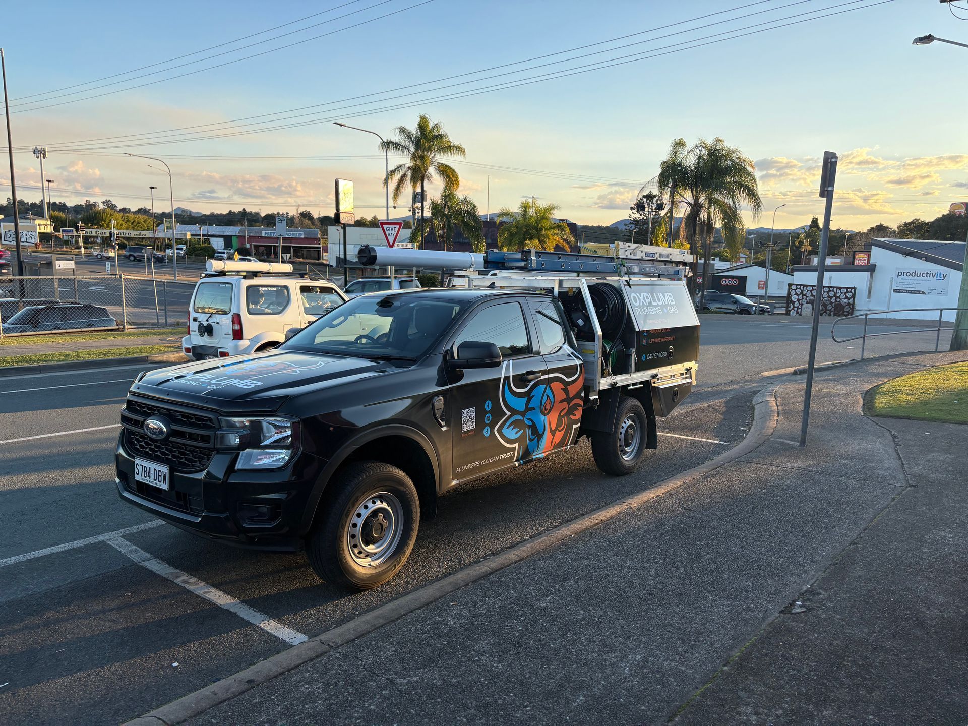 Black Work Truck With Toolboxes Parked in Front of Buildings — Oxplumb in Coolum Beach, QLD