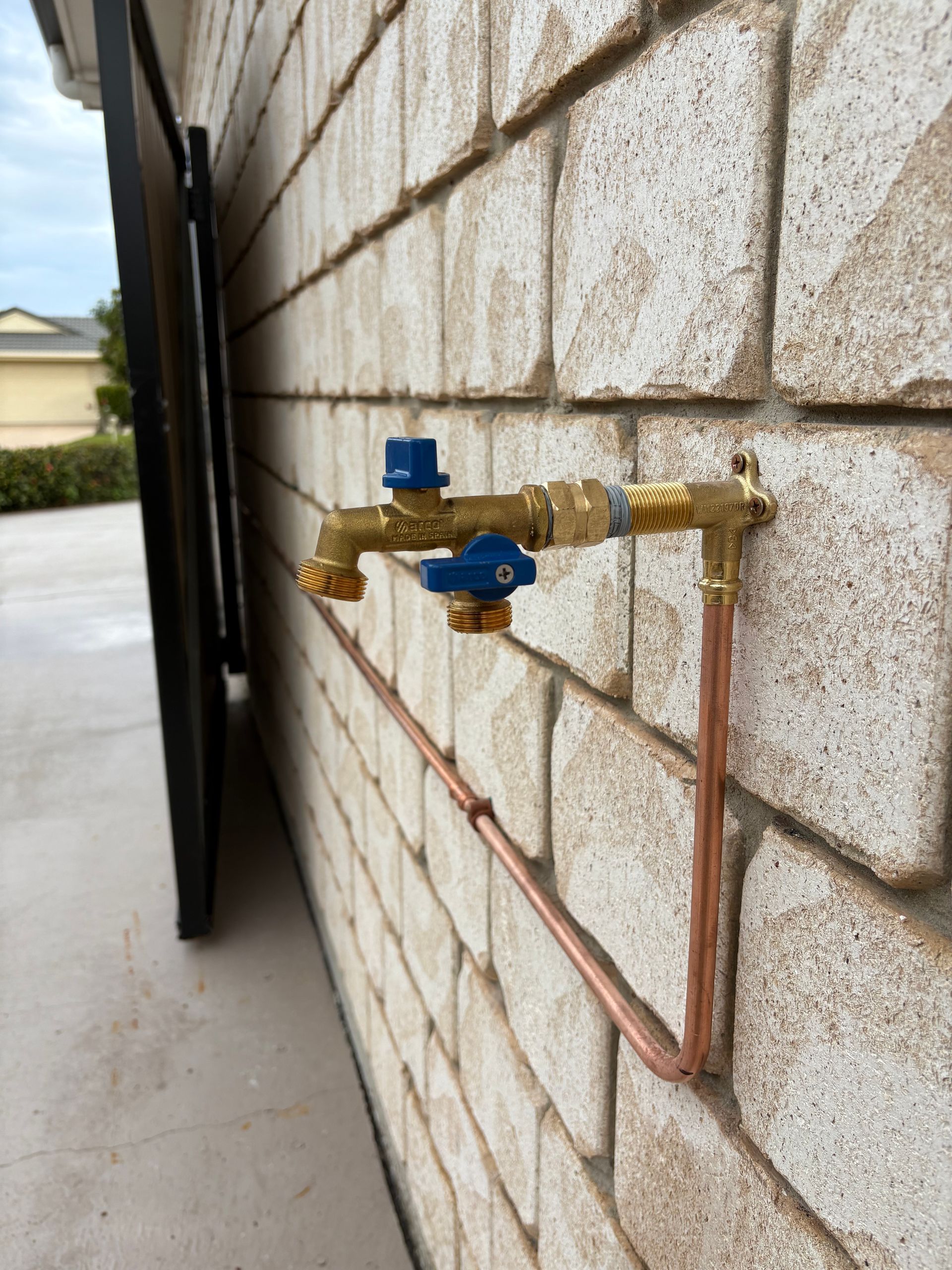 Copper Pipes and Brass Faucet Attached to a Brick Wall — Oxplumb in Nambour, QLD