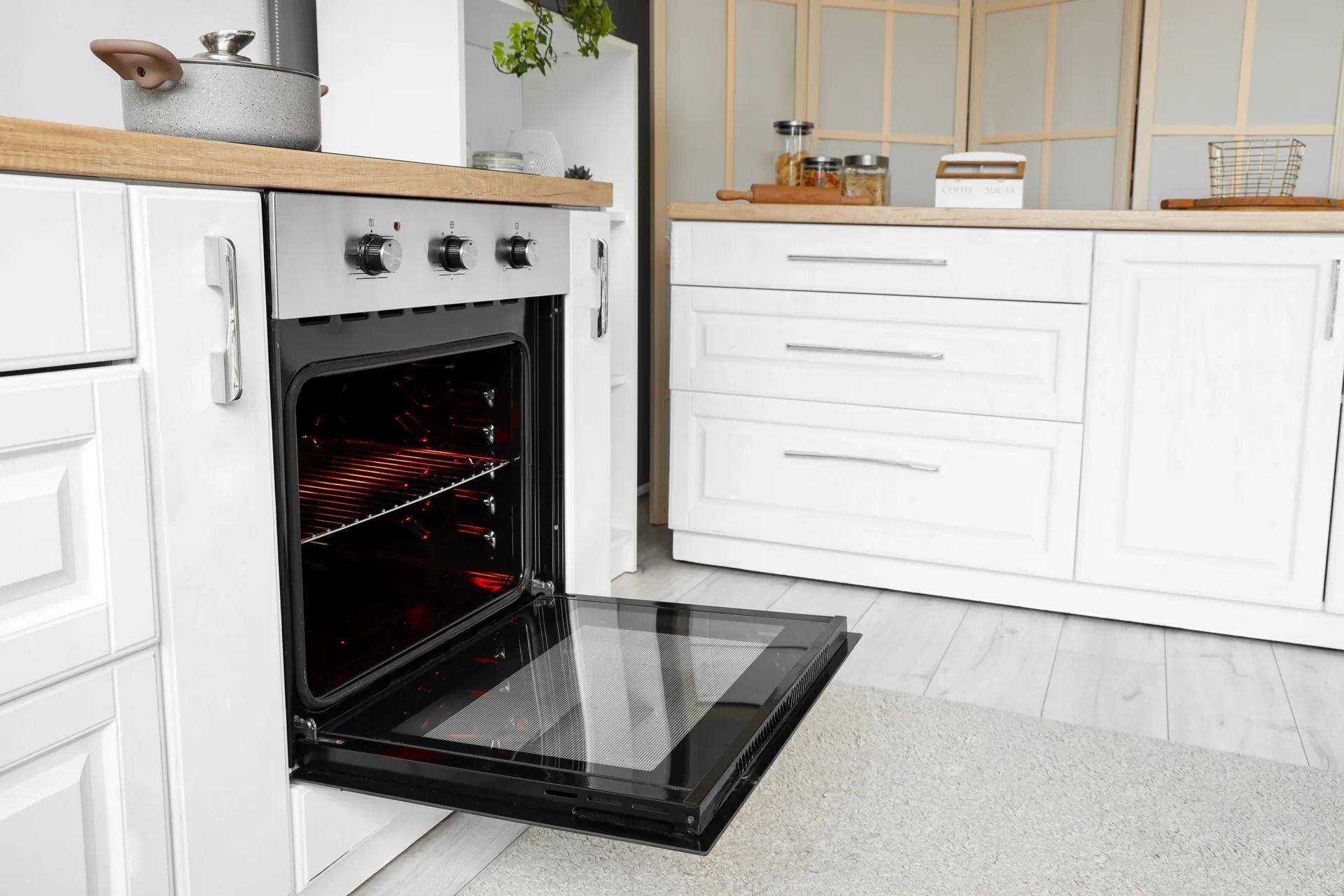 A Kitchen Interior Showing a Modern White Oven with Its Door Open — Central Coast Washing Machines & Refrigerator Repairs in San Remo, NSW