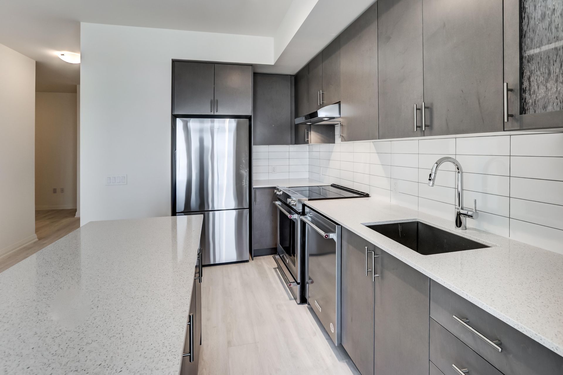 Modern Kitchen with Gray Cabinets, Stainless Steel Appliances — Central Coast Washing Machines & Refrigerator Repairs in Gosford, NSW