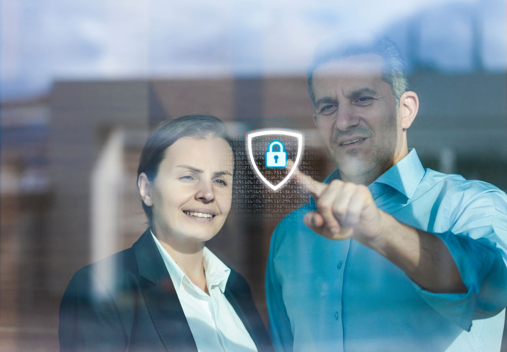 A Man and A Woman Are Looking at A Screen with A Padlock on It — Gold Coast, Qld — Australian Security Company