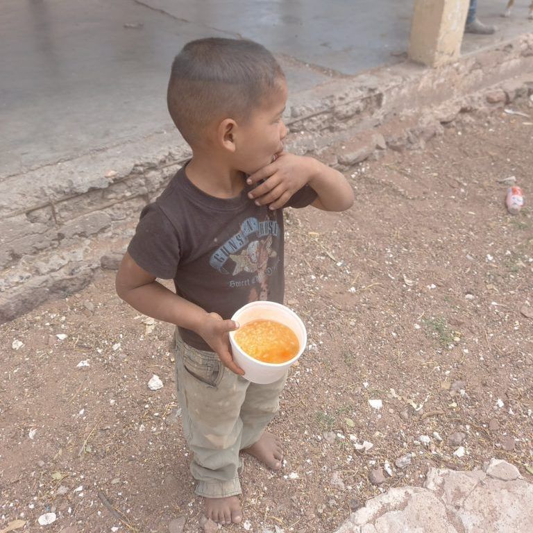A young boy wearing a shirt that says ' surf ' on it