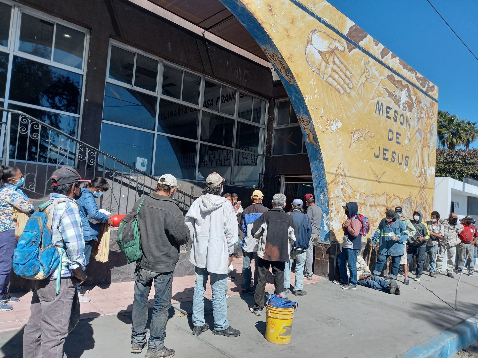 A group of people are standing in front of a building.