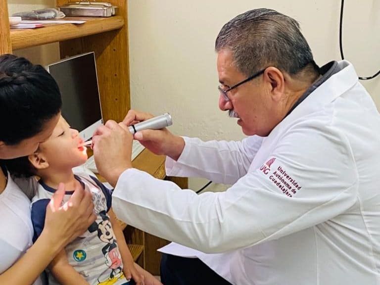 A doctor is examining a child 's ear with a stethoscope.