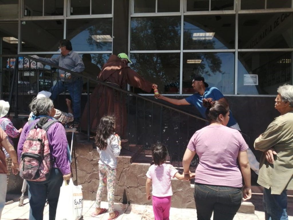 A group of people are standing outside of a building