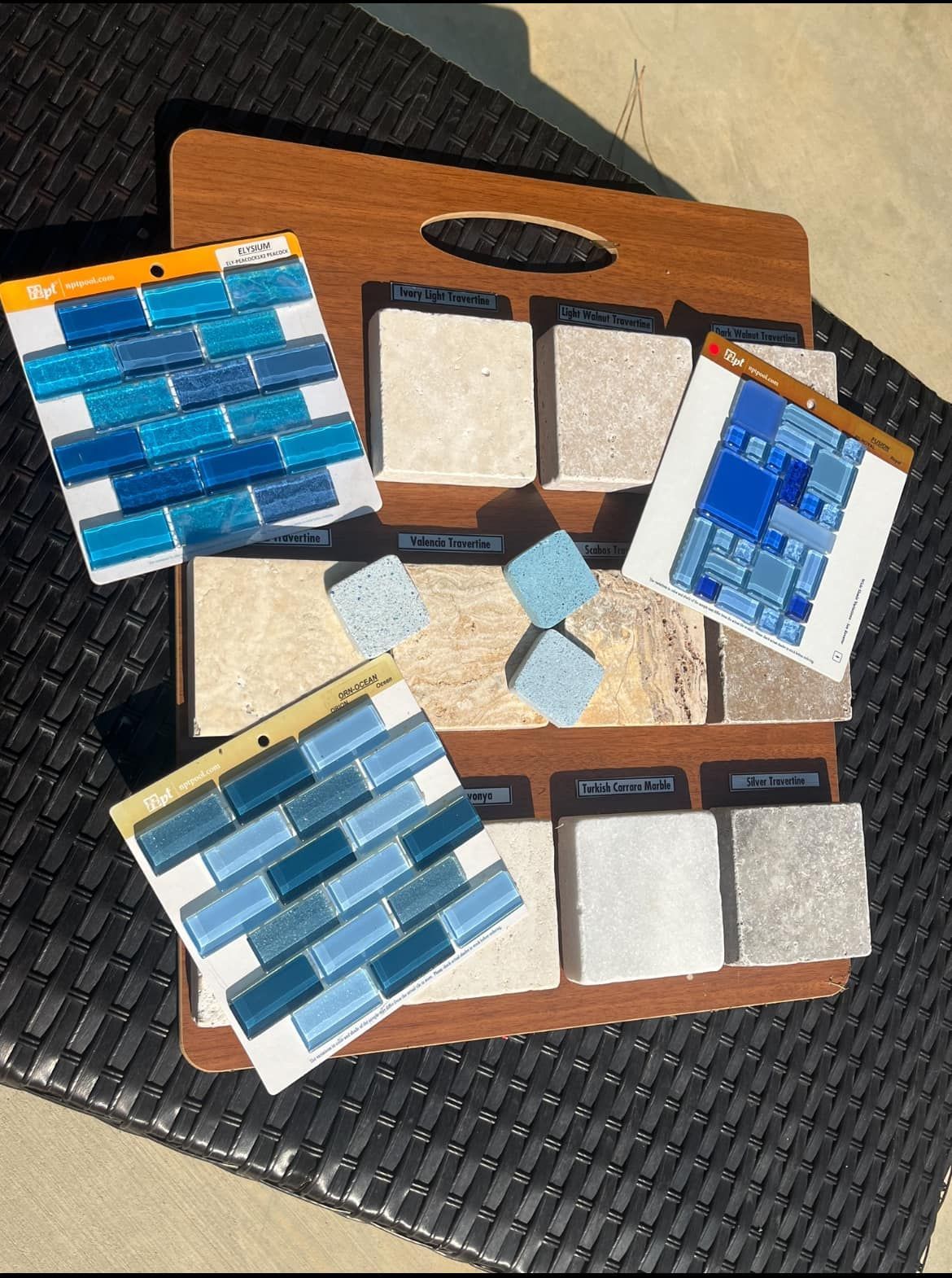 A wooden tray filled with blue and white tiles