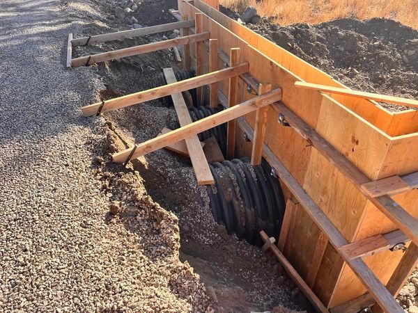 A wooden structure is being built in the dirt