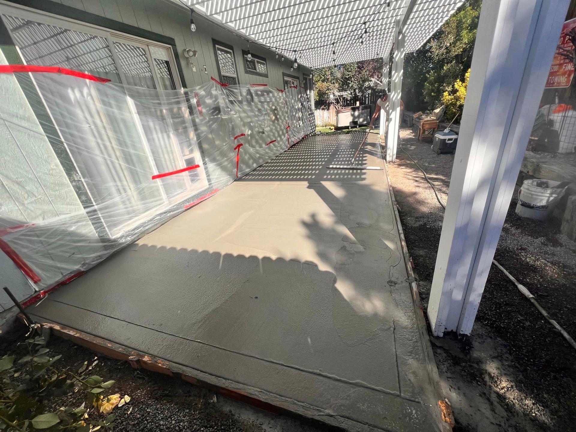 A concrete walkway is being built in front of a house.