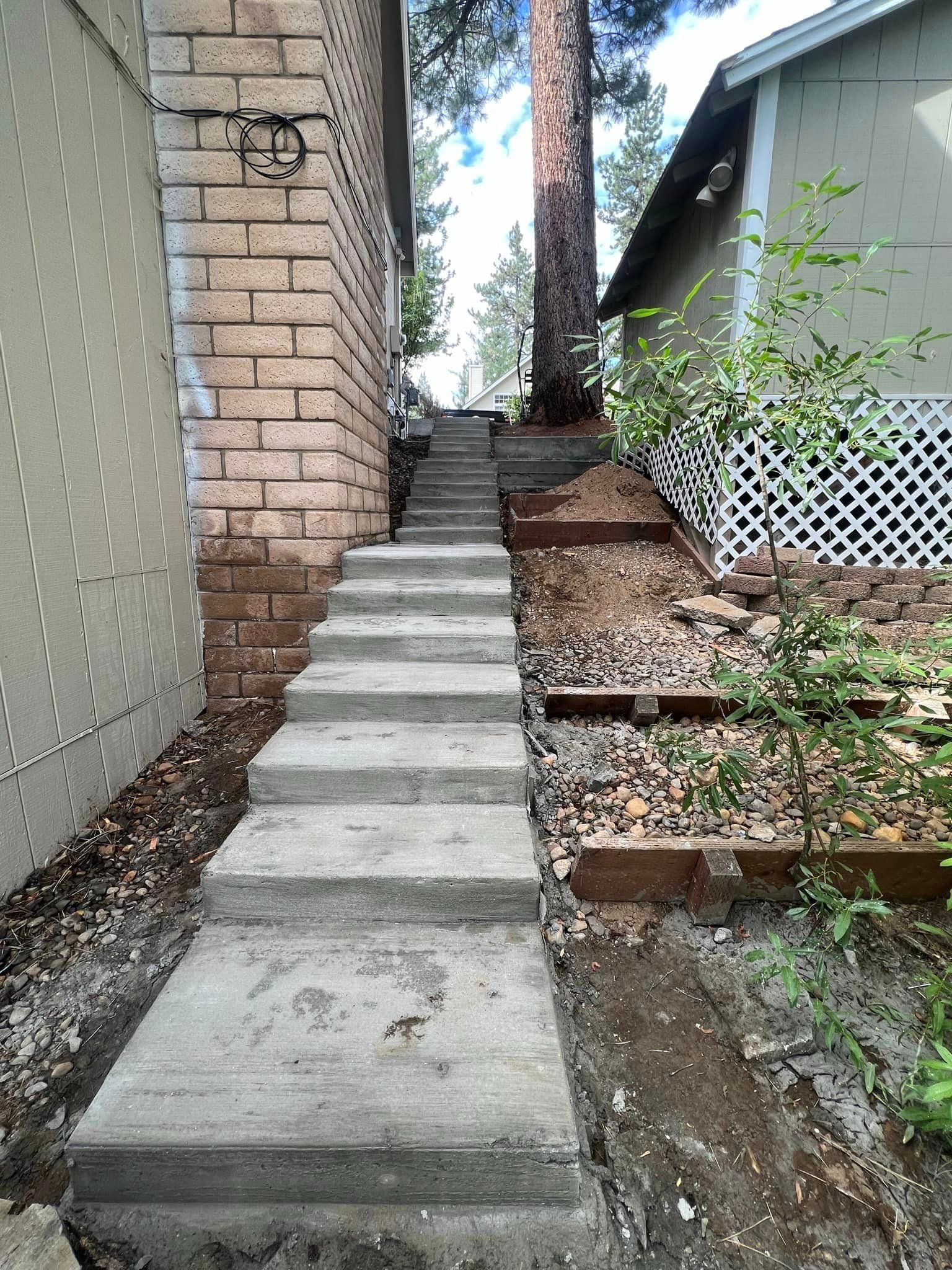 A set of concrete stairs leading up to a house.