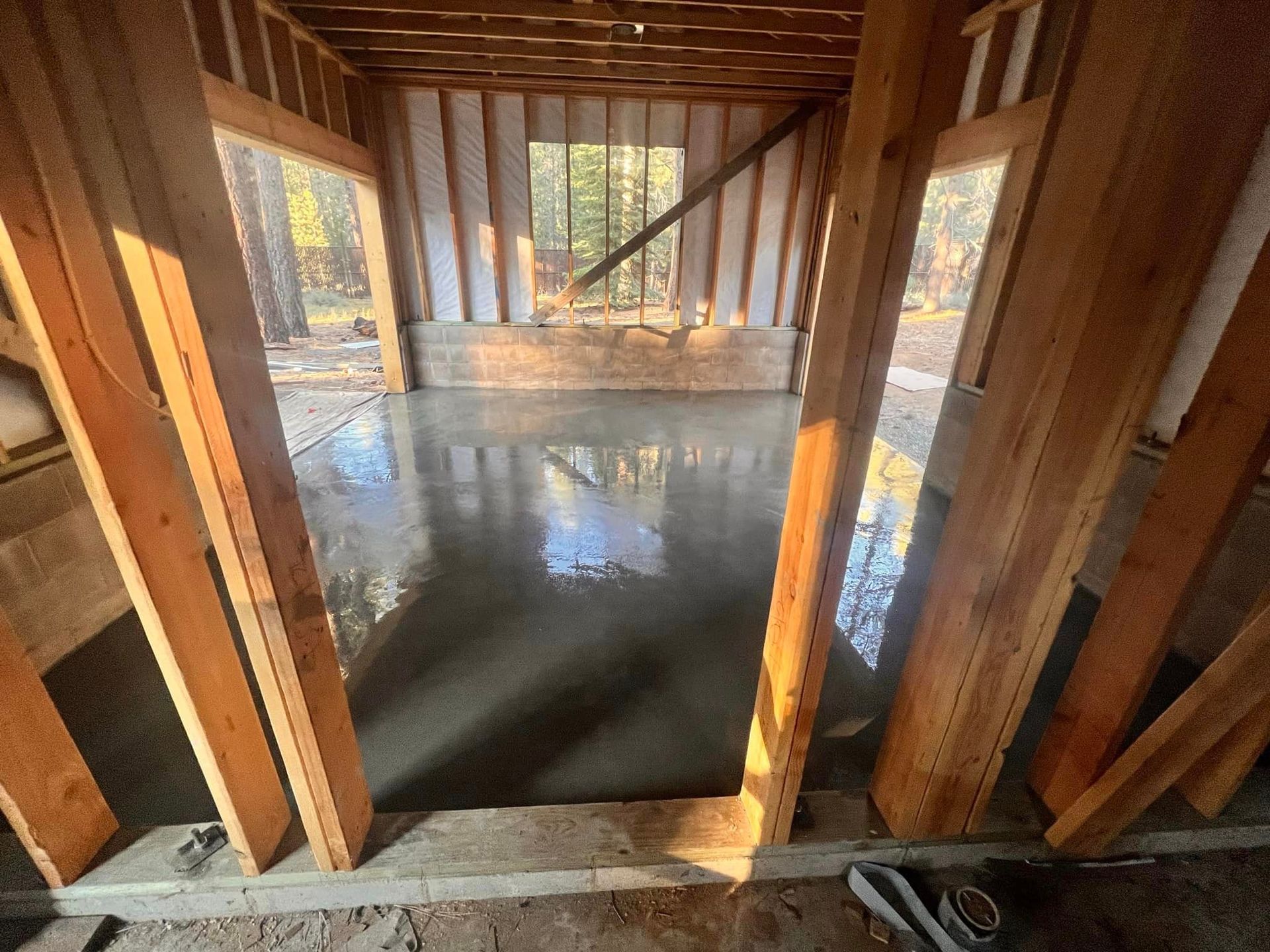 A room in a house under construction with a concrete floor.