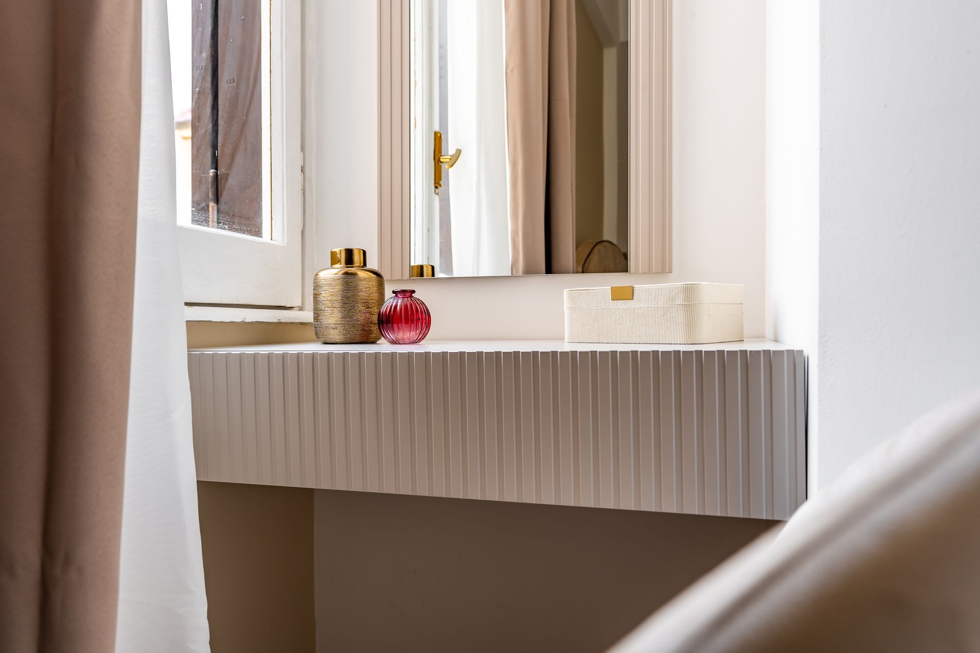 A bathroom with a vanity and a mirror.